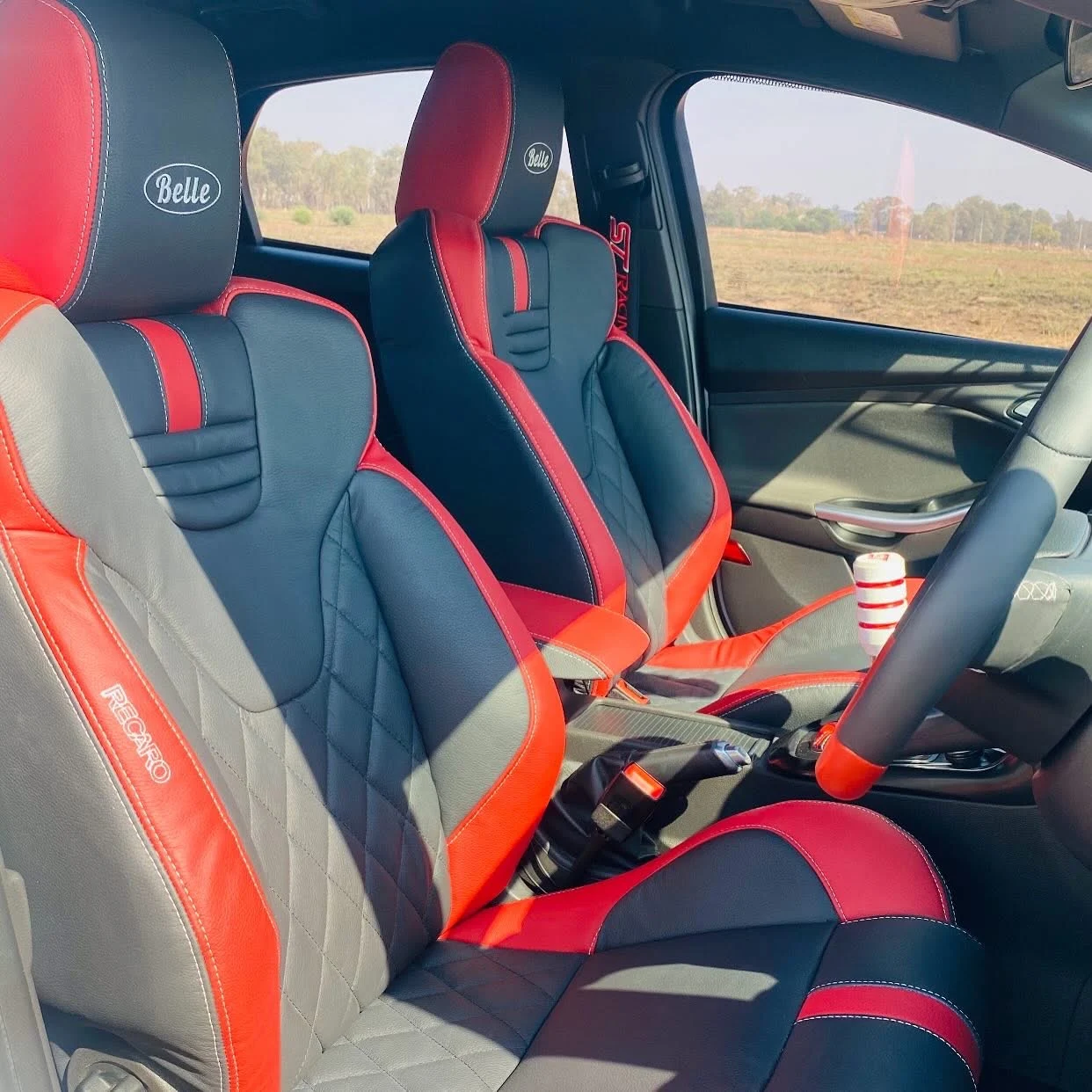 Custom red and black leather front seats by Leatherboyz